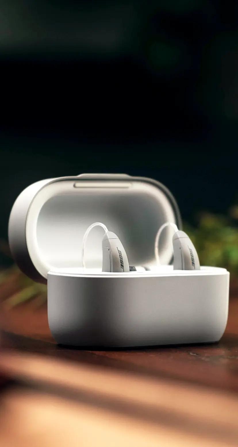 Mobile image of Lexie B2 Powered by Bose hearing aids on a table with herbs.