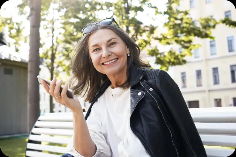 Lady smile while holding her phone