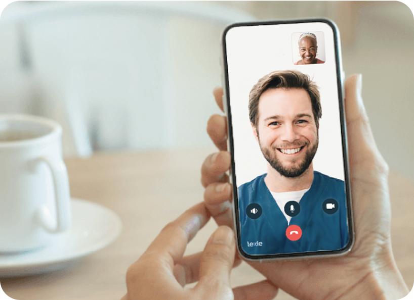 Hand holding a phone speaking with a Lexie Expert over video call.