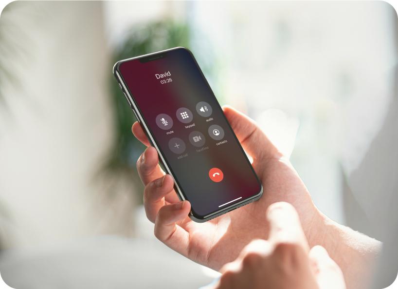 Hand holding a phone streaming an iPhone call from the phone to Lexie hearing aids.