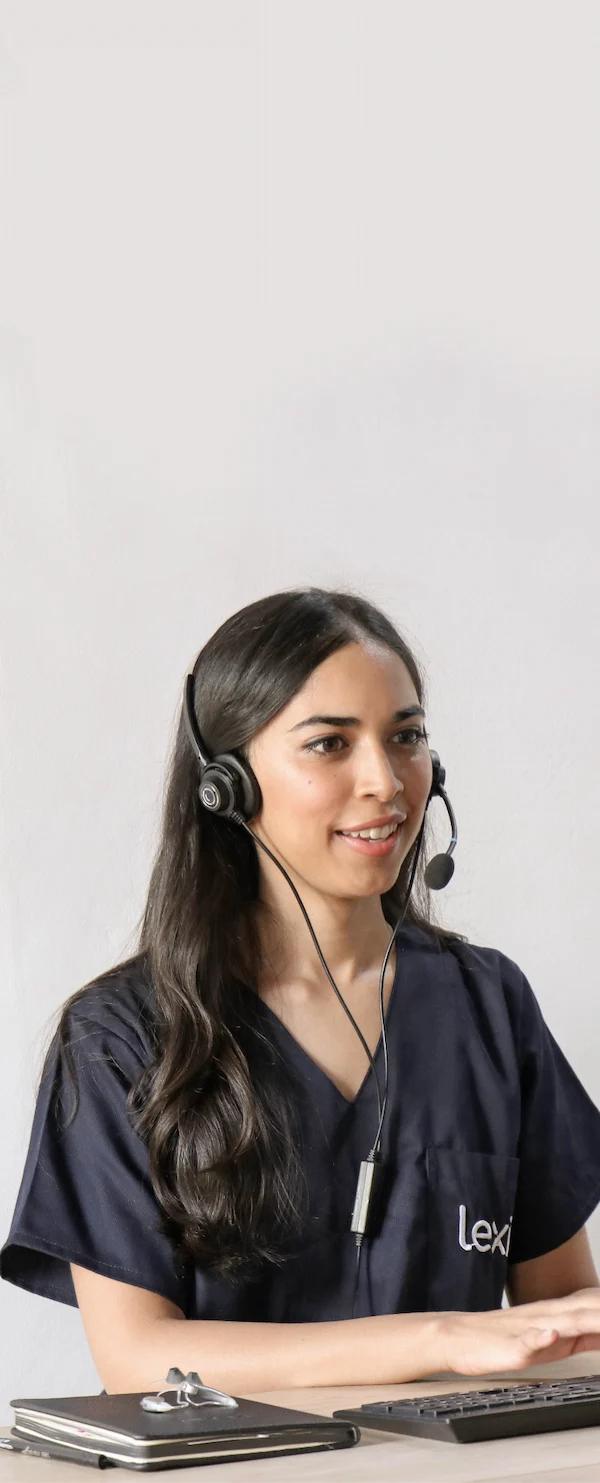Lexie Expert wearing a headset conducting a call on her desktop.