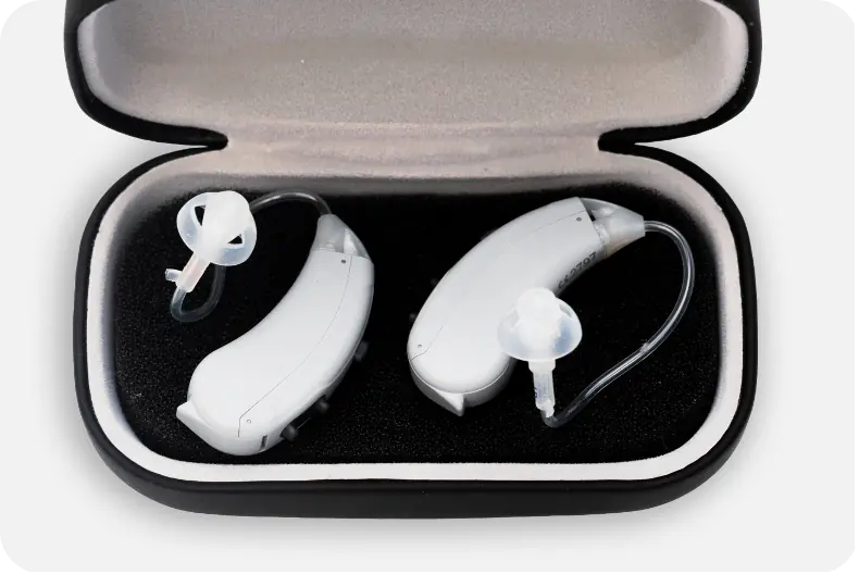 A pair of Lexie Lumen hearing aids in their protective case