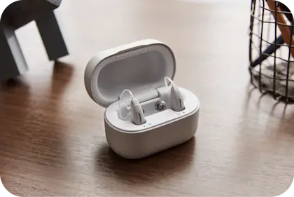 Bose hearing aids next to their case