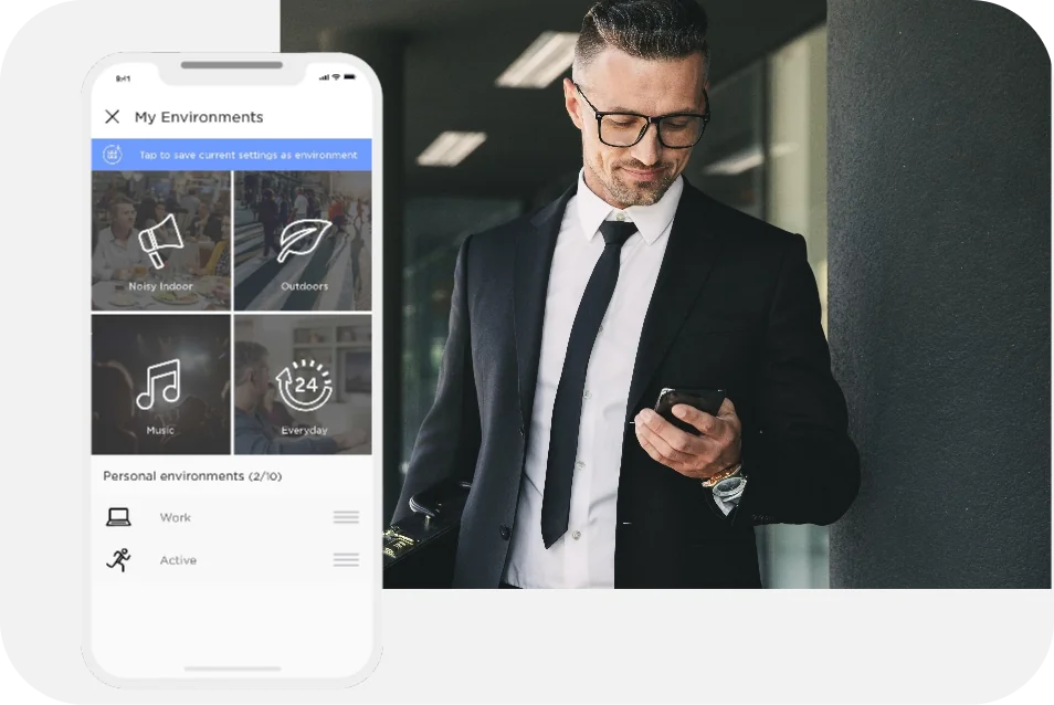 A screenshot of the Lexie Hearing App's environmental selection page. To the right is a man, in suite, looking at her phone.